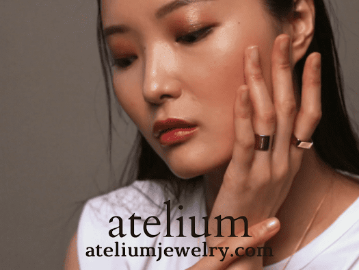 woman with her hand on her face showng jewelry